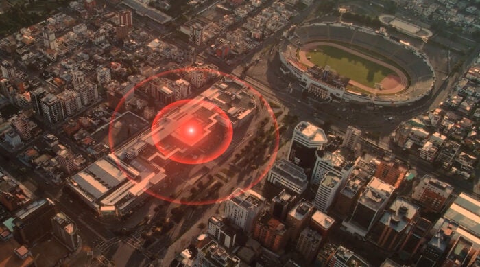 aerial shot of a downtown area with a red target hovering an area.